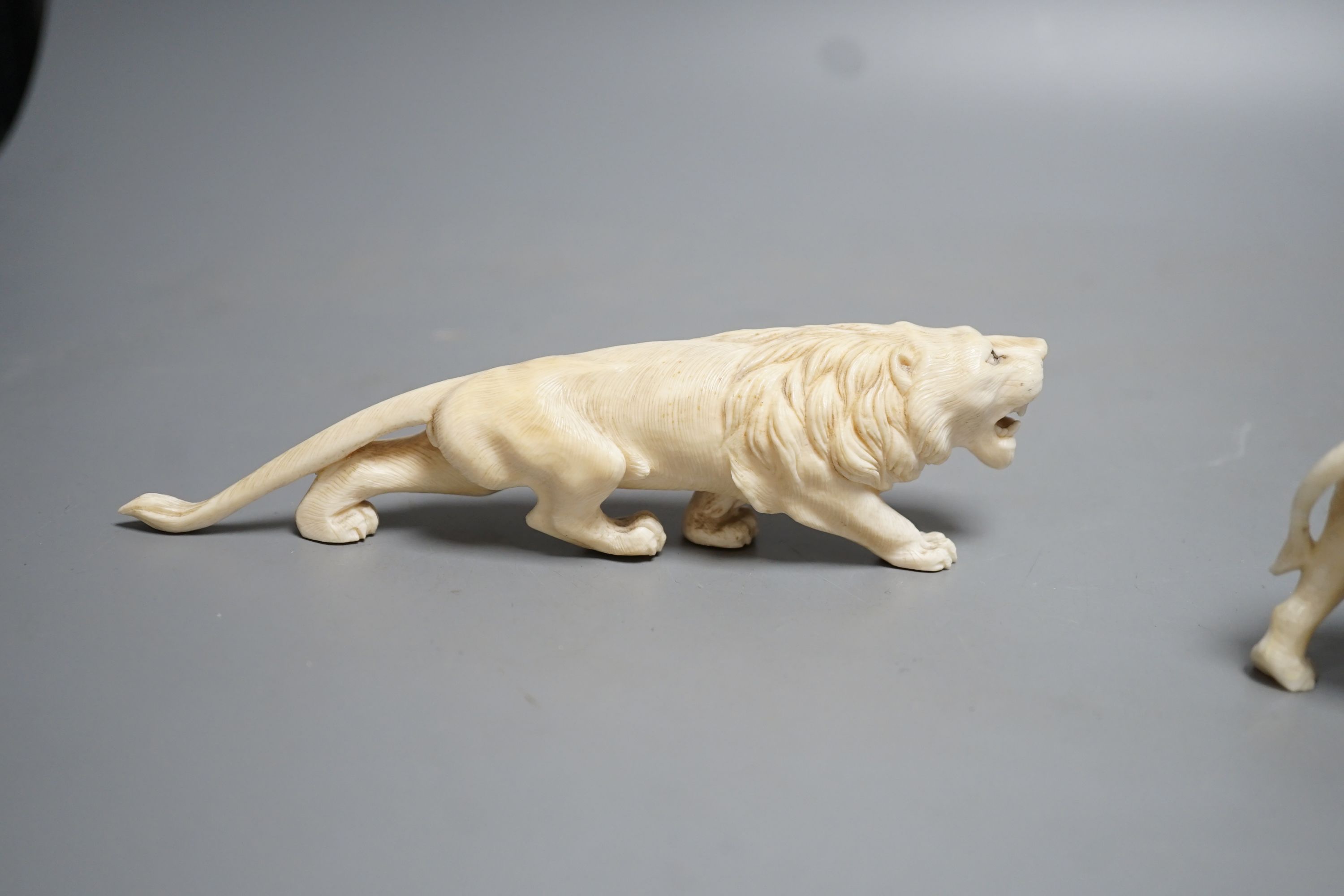 A Japanese Ivory model of an elephant and a similar Ivory model of a lion, early 20th century (2) lion 17cm long